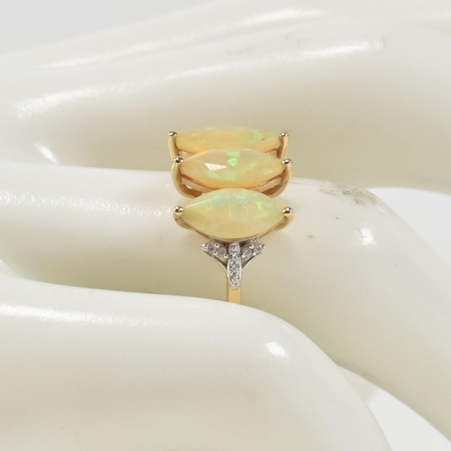 396 - A hallmarked 9ct gold and opal three stone ring. The ring set with three marquise cut opals to shoul... 