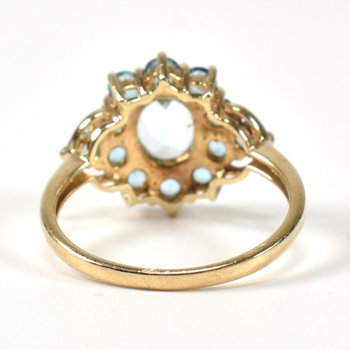 398 - A hallmarked 9ct gold and topaz cluster ring. The ring having a central four claw set oval cut topaz... 