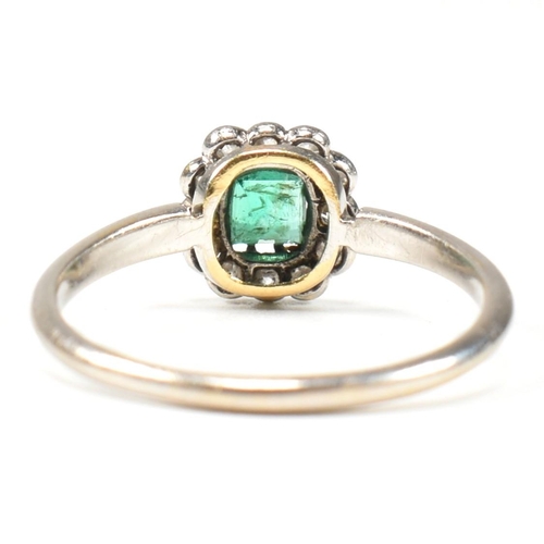 4 - A 1920s emerald and diamond cluster ring. The ring set with a central emerald framed by old cut diam... 