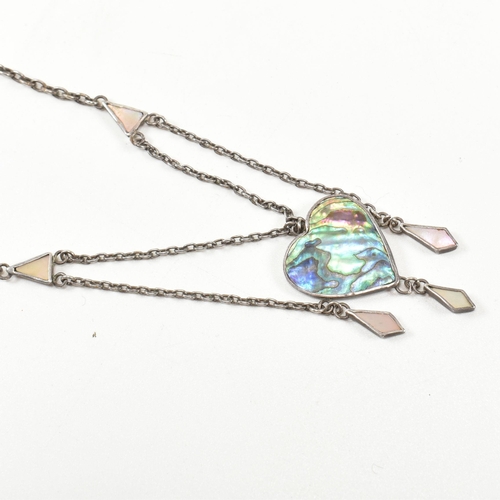 405 - An Arts and Crafts style sterling silver and abalone pendant necklace. The necklace strung with an a... 