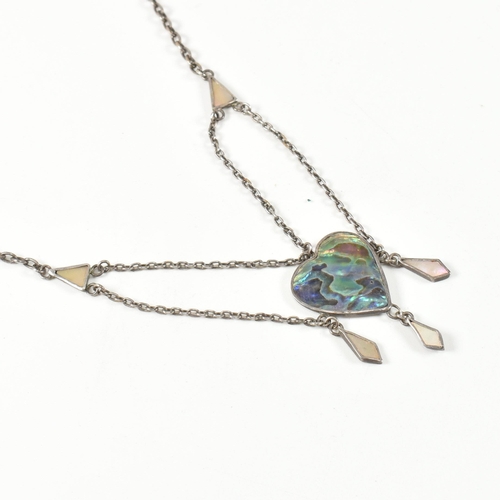 405 - An Arts and Crafts style sterling silver and abalone pendant necklace. The necklace strung with an a... 