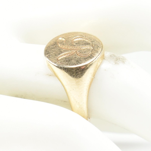 409 - A 9ct gold signet ring with initial monogram. The ring with central roundel cartouche having engrave... 