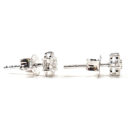 41 - A pair of hallmarked 9ct white gold and diamond daisy cluster earrings. Measures head 5mm. All weigh... 