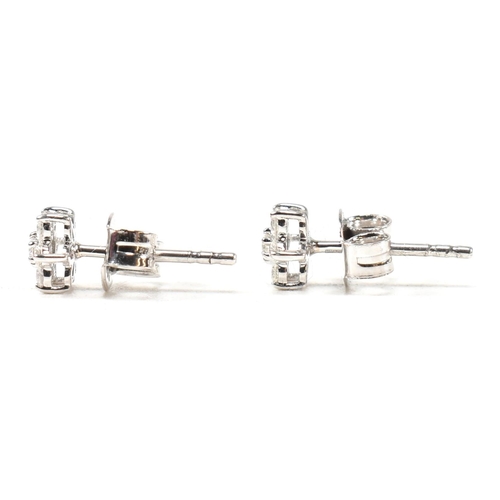 41 - A pair of hallmarked 9ct white gold and diamond daisy cluster earrings. Measures head 5mm. All weigh... 