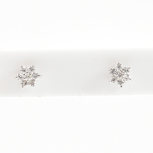 41 - A pair of hallmarked 9ct white gold and diamond daisy cluster earrings. Measures head 5mm. All weigh... 