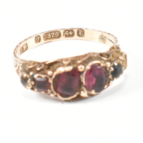 411 - A Victorian hallmarked 9ct gold and gem set half hoop ring. The ring set with flat cut red, white, p... 