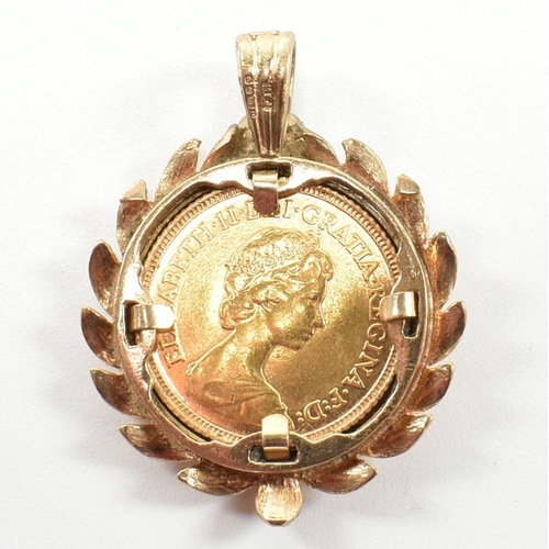 42 - A hallmarked 9ct gold half sovereign mounted necklace pendant. The pendant formed with a laurel leaf... 