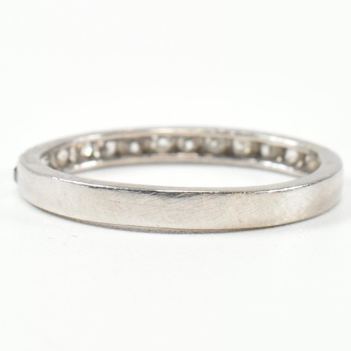 422 - An 18ct white gold and diamond half eternity ring. The half eternity ring set with round brilliant c... 