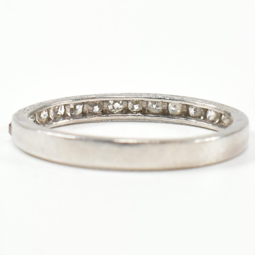 422 - An 18ct white gold and diamond half eternity ring. The half eternity ring set with round brilliant c... 