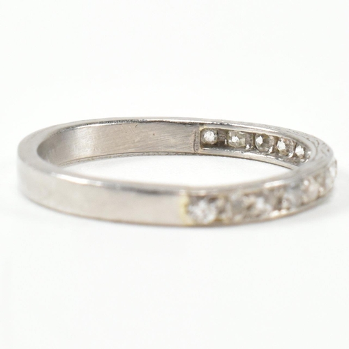 422 - An 18ct white gold and diamond half eternity ring. The half eternity ring set with round brilliant c... 