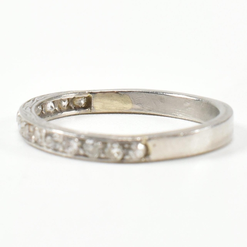 422 - An 18ct white gold and diamond half eternity ring. The half eternity ring set with round brilliant c... 