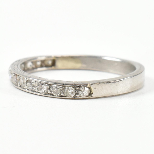 422 - An 18ct white gold and diamond half eternity ring. The half eternity ring set with round brilliant c... 