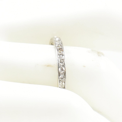 422 - An 18ct white gold and diamond half eternity ring. The half eternity ring set with round brilliant c... 