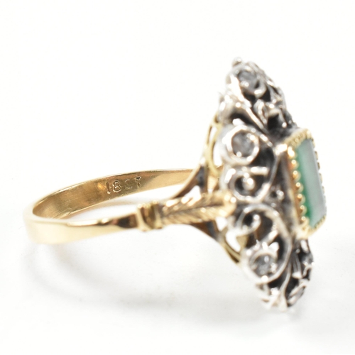 423 - Continental emerald and diamond cluster ring. The ring having a scrolled foliate head set with a cen... 