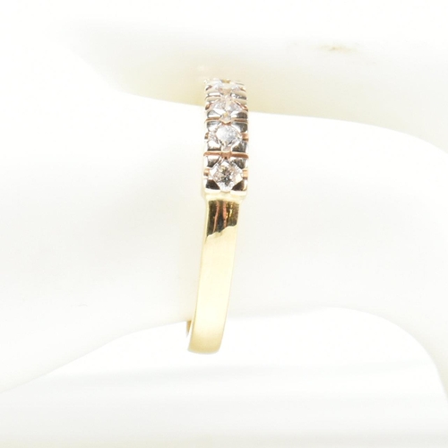 424 - An 18ct gold and diamond half hoop ring. The gold ring set with seven round brilliant cut diamonds i... 