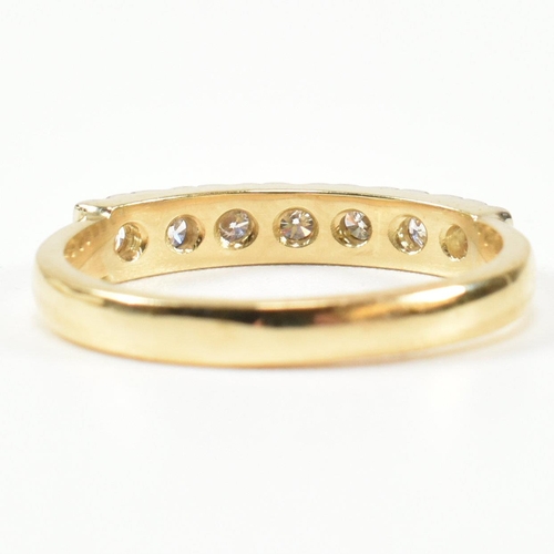 424 - An 18ct gold and diamond half hoop ring. The gold ring set with seven round brilliant cut diamonds i... 