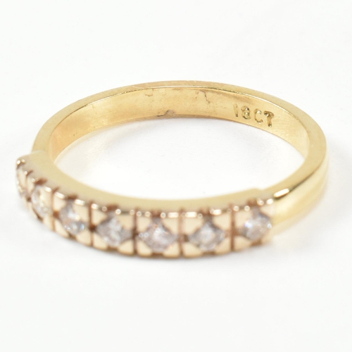 424 - An 18ct gold and diamond half hoop ring. The gold ring set with seven round brilliant cut diamonds i... 