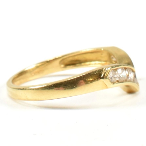 428 - A hallmarked 18ct gold and diamond wishbone ring. The wishbone ring set with a row of seven channel ... 