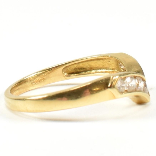 428 - A hallmarked 18ct gold and diamond wishbone ring. The wishbone ring set with a row of seven channel ... 