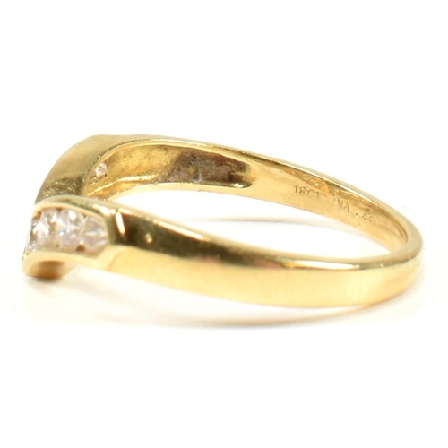 428 - A hallmarked 18ct gold and diamond wishbone ring. The wishbone ring set with a row of seven channel ... 