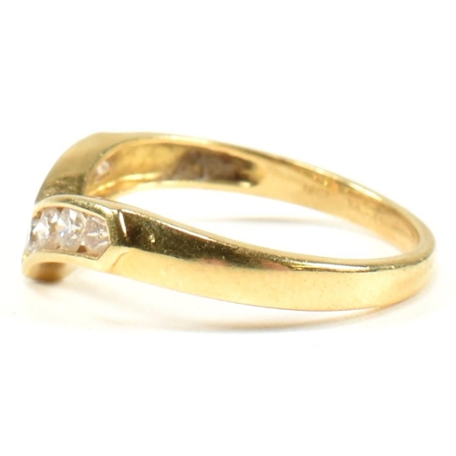 428 - A hallmarked 18ct gold and diamond wishbone ring. The wishbone ring set with a row of seven channel ... 