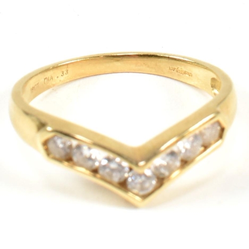 428 - A hallmarked 18ct gold and diamond wishbone ring. The wishbone ring set with a row of seven channel ... 