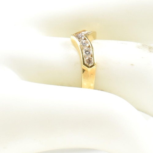 428 - A hallmarked 18ct gold and diamond wishbone ring. The wishbone ring set with a row of seven channel ... 