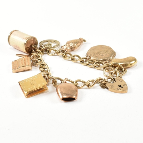 43 - A hallmarked 9ct gold charm bracelet. The charm bracelet having nine gold charms strung on a 9ct gol... 