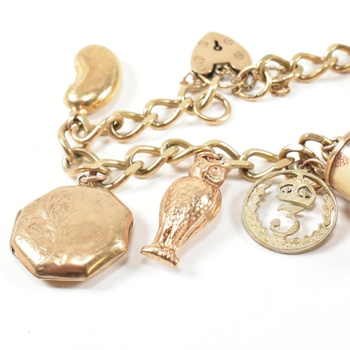 43 - A hallmarked 9ct gold charm bracelet. The charm bracelet having nine gold charms strung on a 9ct gol... 