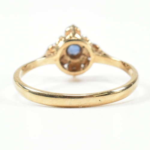 431 - A hallmarked 9ct gold, sapphire and diamond cluster ring. The ring set with a central round cut sapp... 