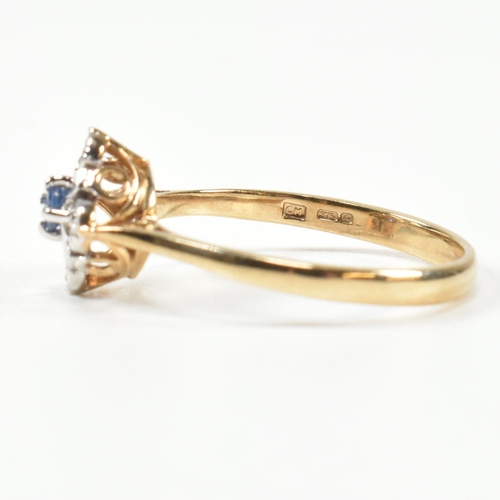 431 - A hallmarked 9ct gold, sapphire and diamond cluster ring. The ring set with a central round cut sapp... 