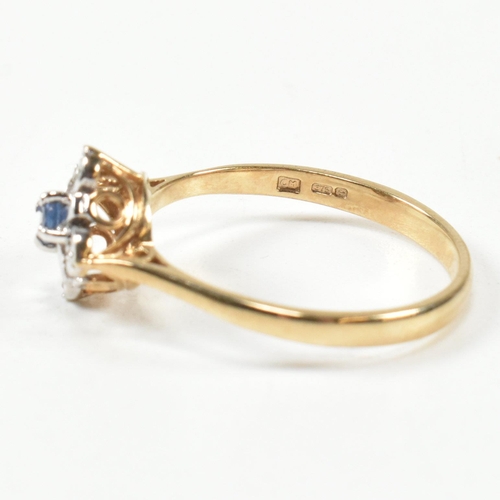 431 - A hallmarked 9ct gold, sapphire and diamond cluster ring. The ring set with a central round cut sapp... 