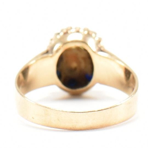 432 - A hallmarked 9ct gold, sapphire and opal cluster ring. The ring set with a central opal cabochon and... 