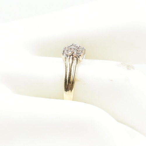 433 - A 9ct gold and diamond cluster ring. The ring set with three rows of round cut diamonds with fluted ... 