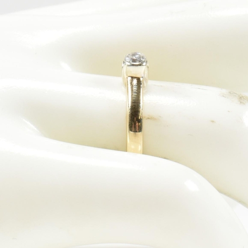 434 - A hallmarked 9ct gold and diamond solitaire ring. The ring set with a single half bezel set round br... 