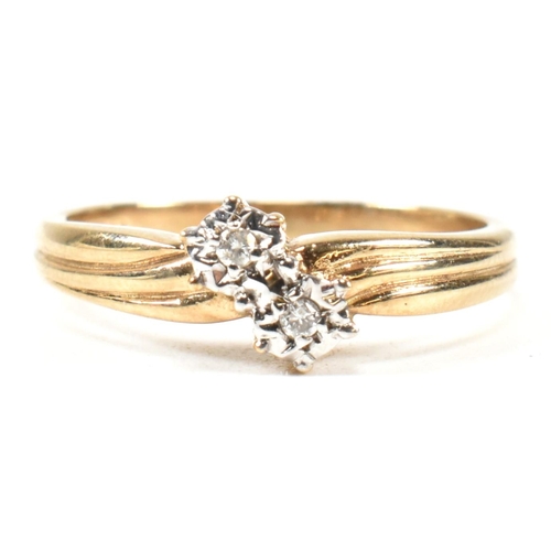 435 - A hallmarked 9ct gold and diamond crossover ring. The ring having two illusion set round cut diamond... 