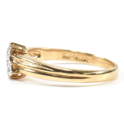 435 - A hallmarked 9ct gold and diamond crossover ring. The ring having two illusion set round cut diamond... 