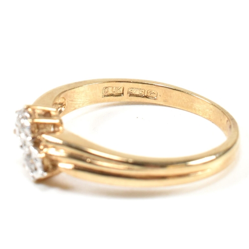 435 - A hallmarked 9ct gold and diamond crossover ring. The ring having two illusion set round cut diamond... 