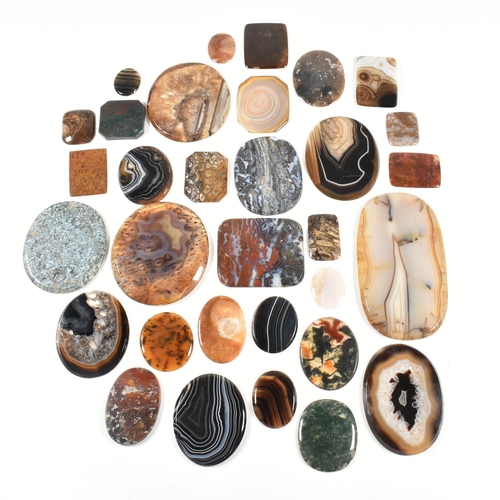 438 - A collection of banded agate, moss agate, bloodstone and jasper specimen slices. Largest 10.7cm. Tot... 