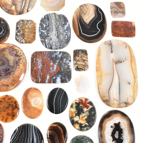 438 - A collection of banded agate, moss agate, bloodstone and jasper specimen slices. Largest 10.7cm. Tot... 