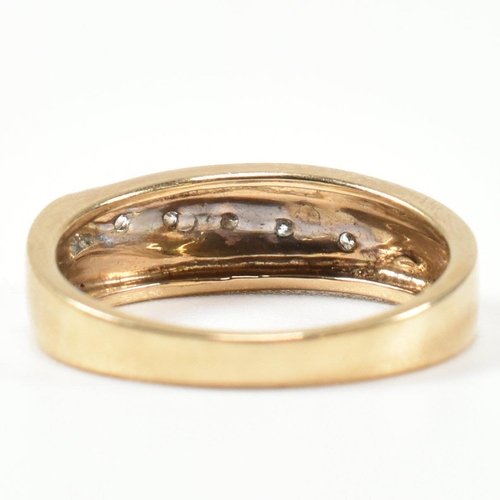 439 - A hallmarked 9ct gold and diamond two-tone band ring. The band ring set with a diagonal row of five ... 