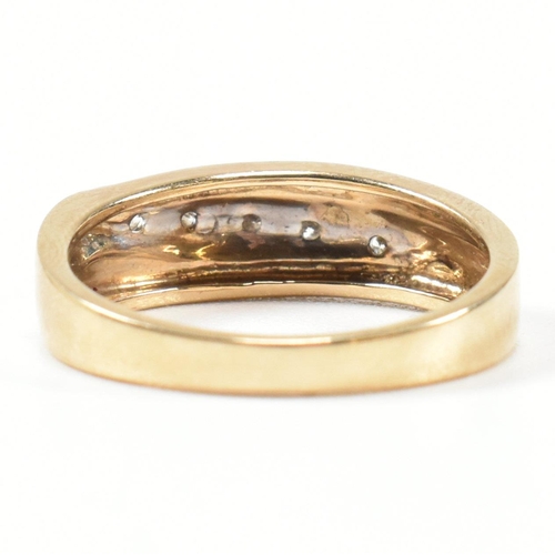 439 - A hallmarked 9ct gold and diamond two-tone band ring. The band ring set with a diagonal row of five ... 