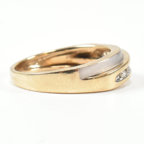 439 - A hallmarked 9ct gold and diamond two-tone band ring. The band ring set with a diagonal row of five ... 