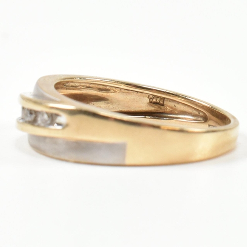 439 - A hallmarked 9ct gold and diamond two-tone band ring. The band ring set with a diagonal row of five ... 