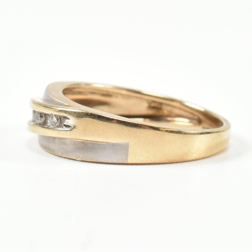 439 - A hallmarked 9ct gold and diamond two-tone band ring. The band ring set with a diagonal row of five ... 