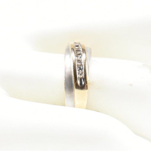 439 - A hallmarked 9ct gold and diamond two-tone band ring. The band ring set with a diagonal row of five ... 