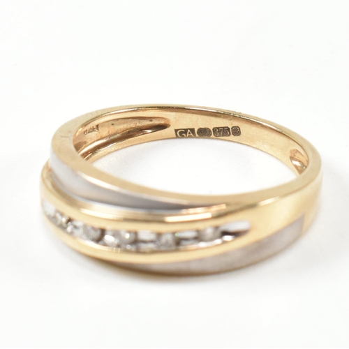 439 - A hallmarked 9ct gold and diamond two-tone band ring. The band ring set with a diagonal row of five ... 