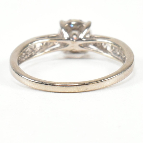 444 - A hallmarked 9ct gold and diamond halo ring. The ring having a central round brilliant cut diamond s... 