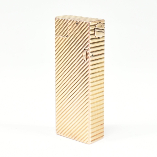 447 - A vintage Dunhill Paris gold plated lighter. The lighter having chevron decoration with roller actio... 