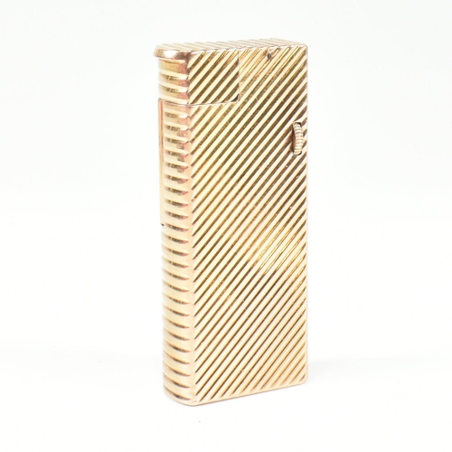 447 - A vintage Dunhill Paris gold plated lighter. The lighter having chevron decoration with roller actio... 